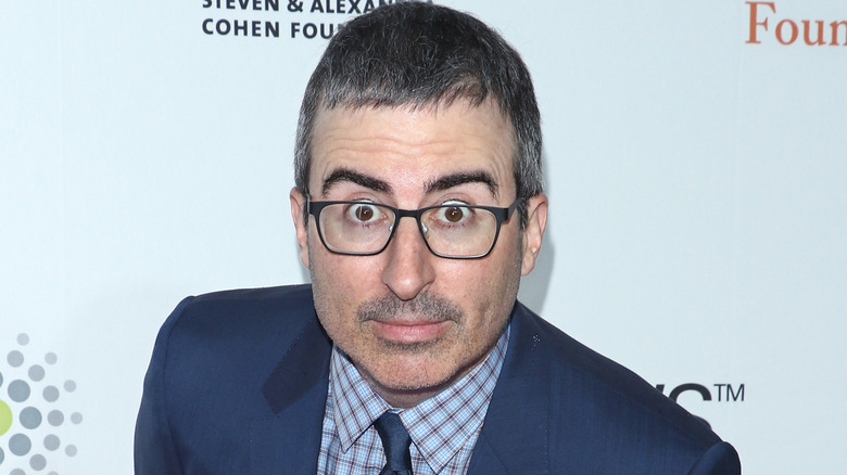 John Oliver leans forward