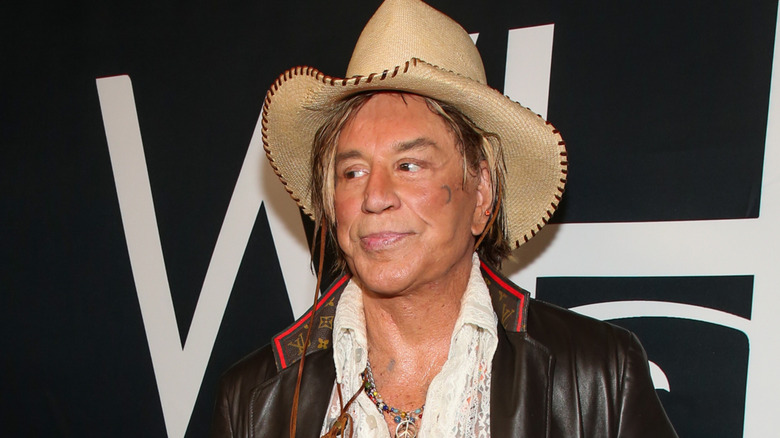 Mickey Rourke wearing a cowboy hat on red carpet at movie preimere