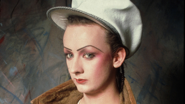 boy george looking sideways big hat