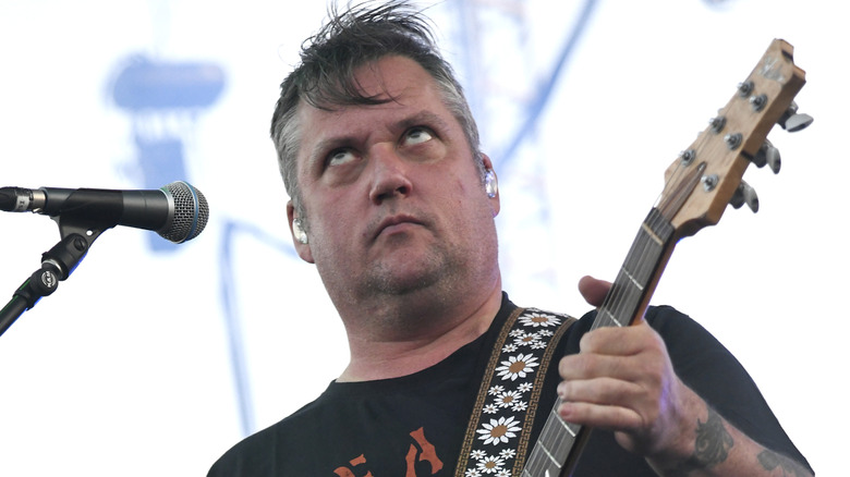 Isaac Brock rolling his eyes while playing guitar with Modest Mouse.