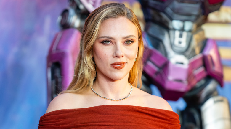 Scarlett Johansson wearing a red dress and smiling