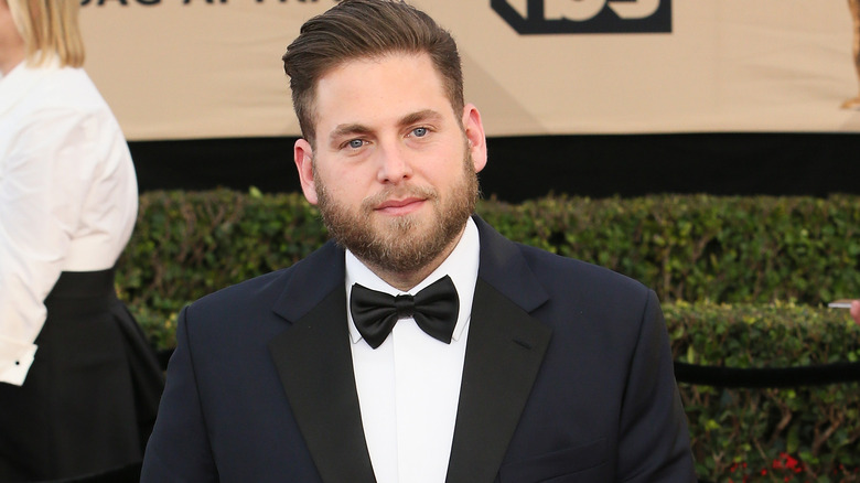 Jonah Hill wearing a suit and bowtie