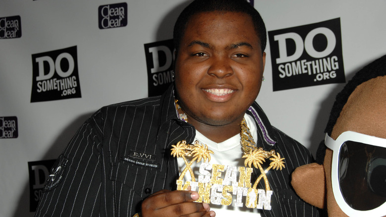 Sean Kingston smiling holding ID necklace