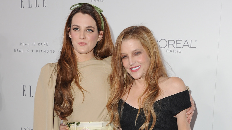 Riley Keough hugging Lisa Marie Presley and posing for a photo