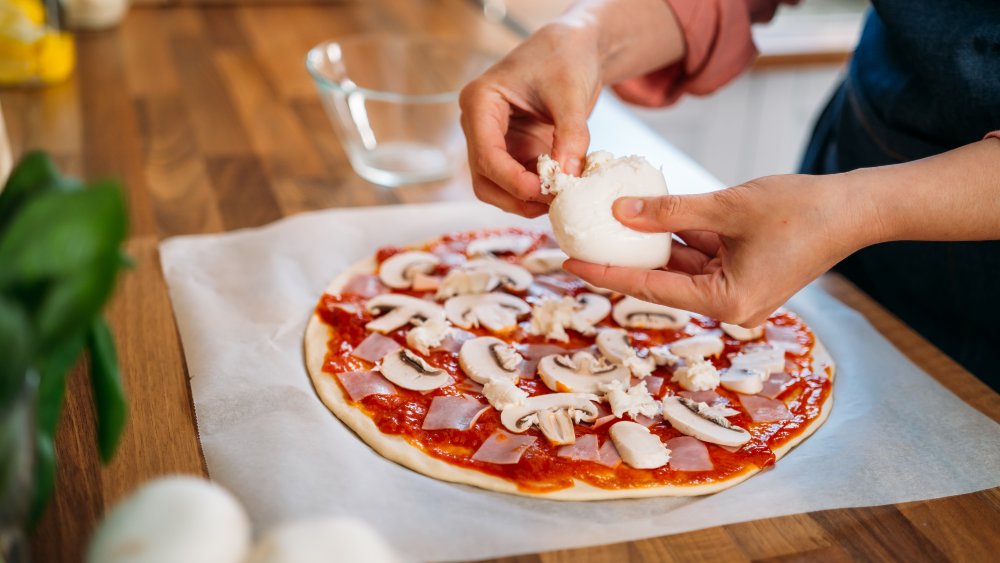 woman making homemade pizza