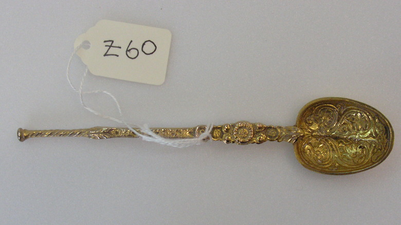 Ornate golden spoon with price tag