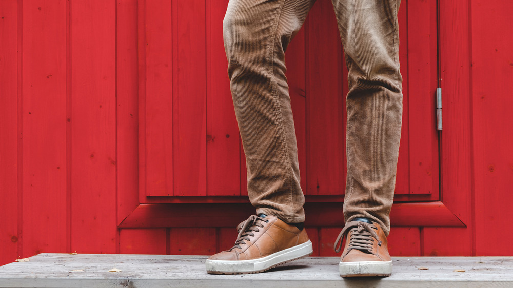 man's feet at a front door