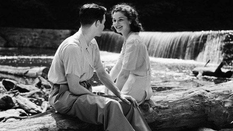 1950s era couple sitting outside