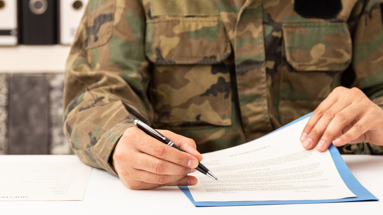 Army personnel signing document