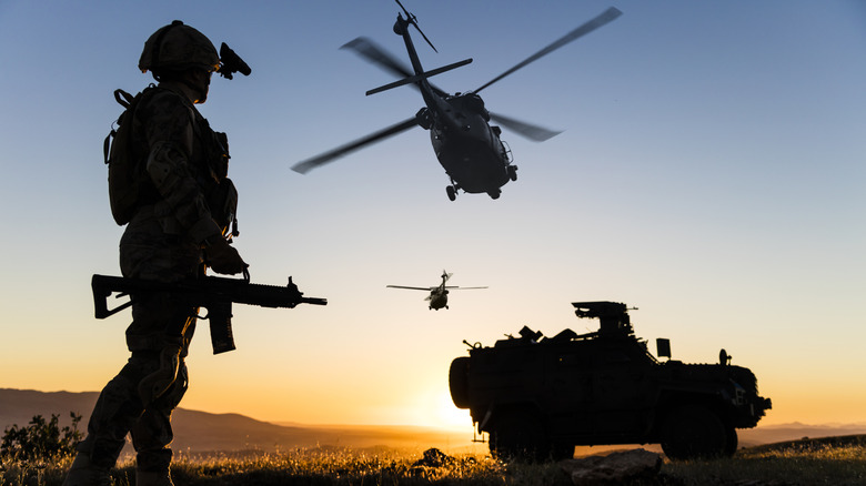 Special forces silhouetted against landscape