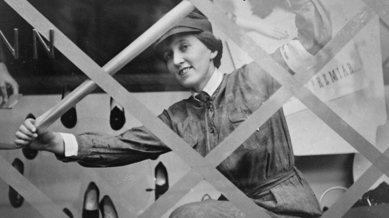 A Finnish woman reinforces a window in Helsinki during WWII