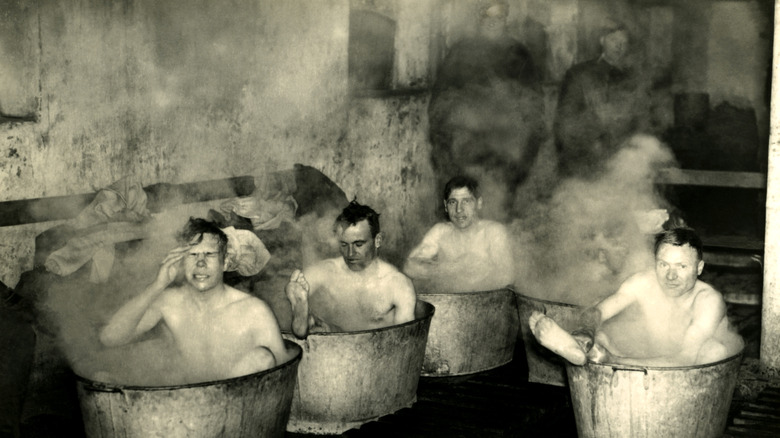 British infantrymen bathing in metal tubs