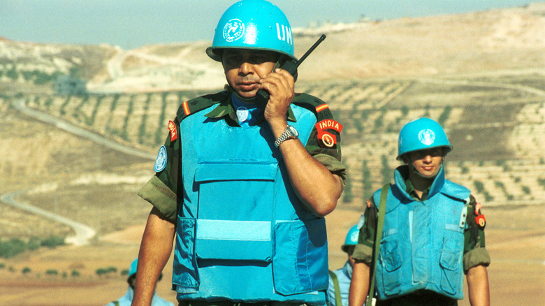 UN Peacekeepers blue helmets vest radios outdoors