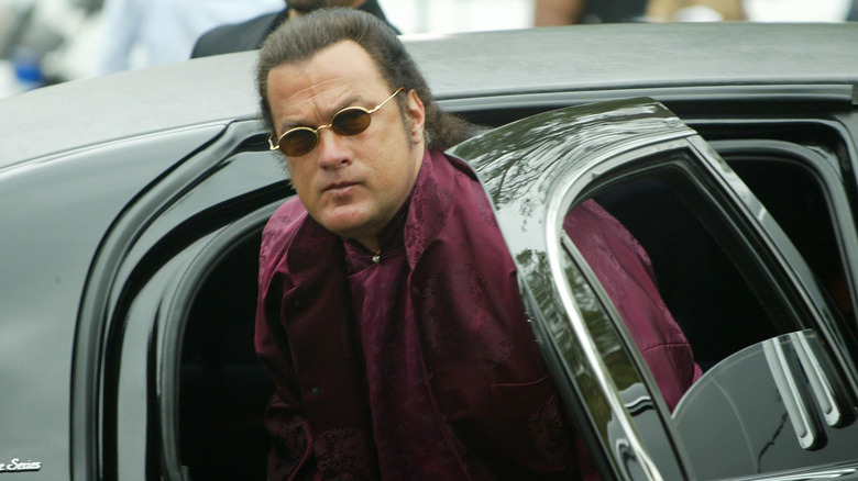 Steven Seagal stepping out of a car