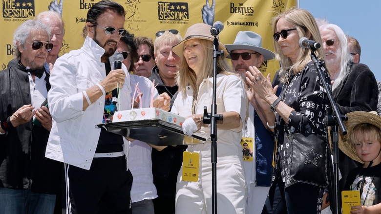 Ringo Starr in a group on stage