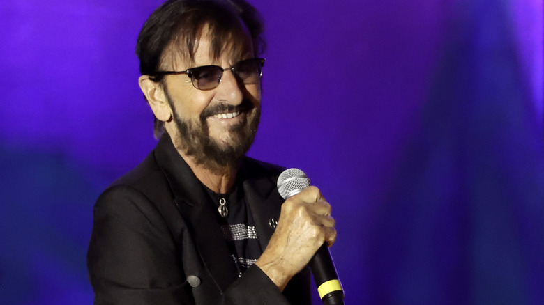 Ringo Starr holding a microphone