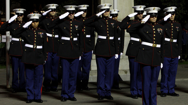 Marines in dress uniform salute