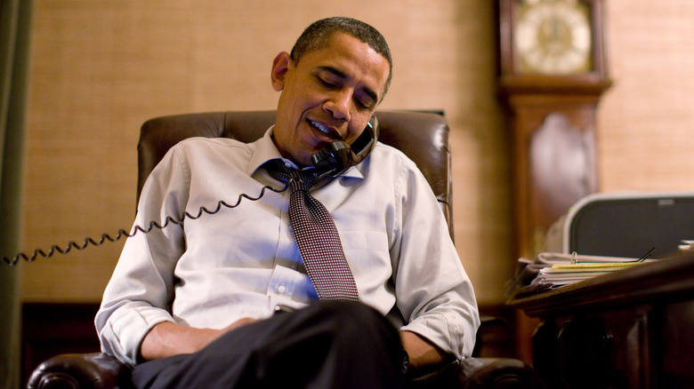 Barack Obama on the telephone seated