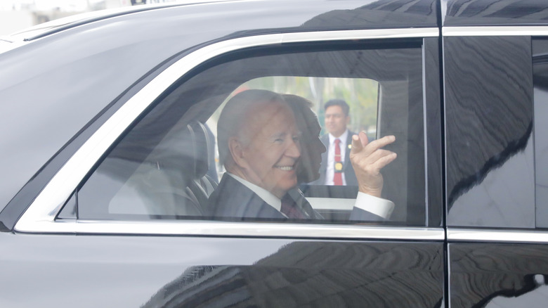 Joe Biden waving from back seat of The Beast