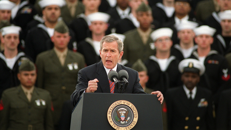 President George W Bush giving speech in front of navy