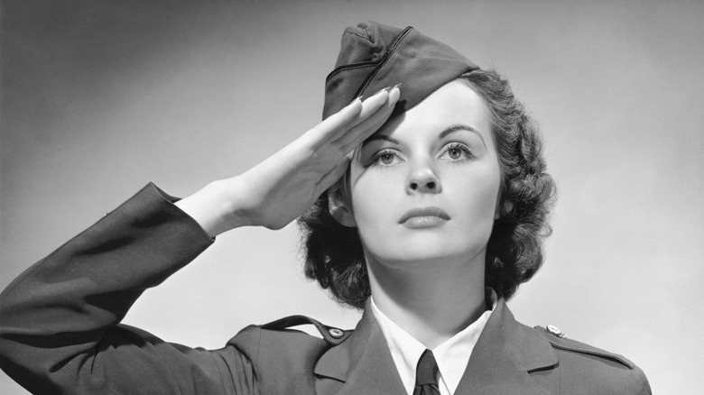 A woman in military dress salutes.