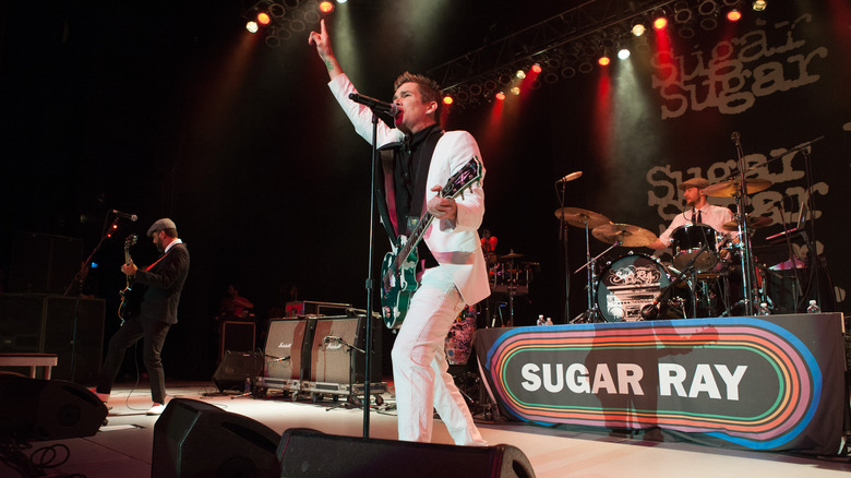 Mark McGrath performs onstage in white suit