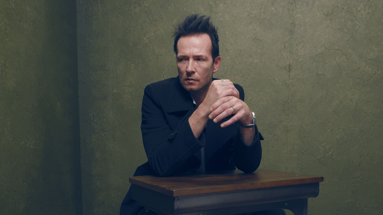 Scott Weiland sitting at a table