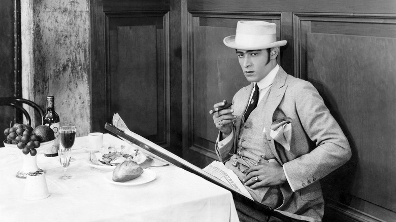 rudolph valentino posing restaurant table