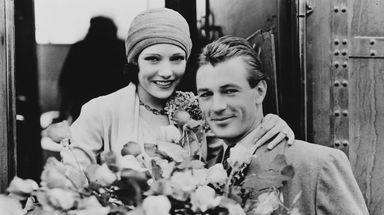 couple smiling with flowers