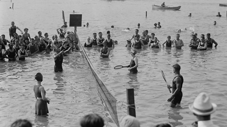 people playing tennis in water