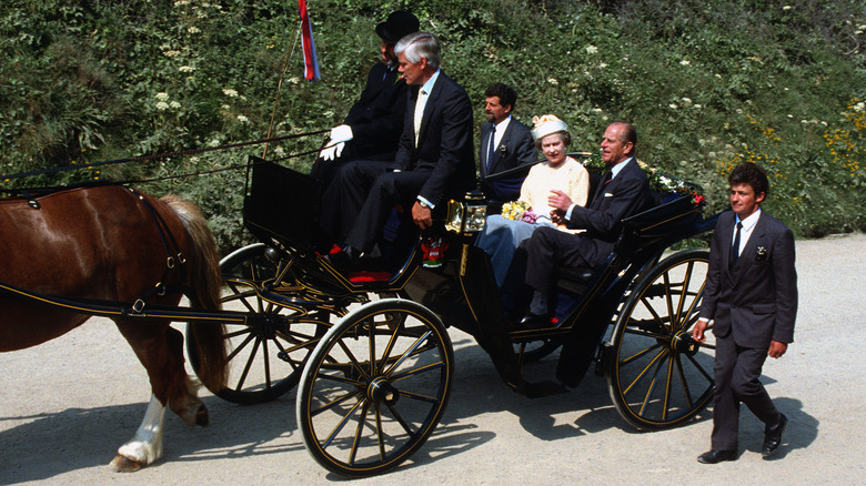 Elizabeth II and Prince Philip take a carriage ride on the Isle of Sark, Guernsey