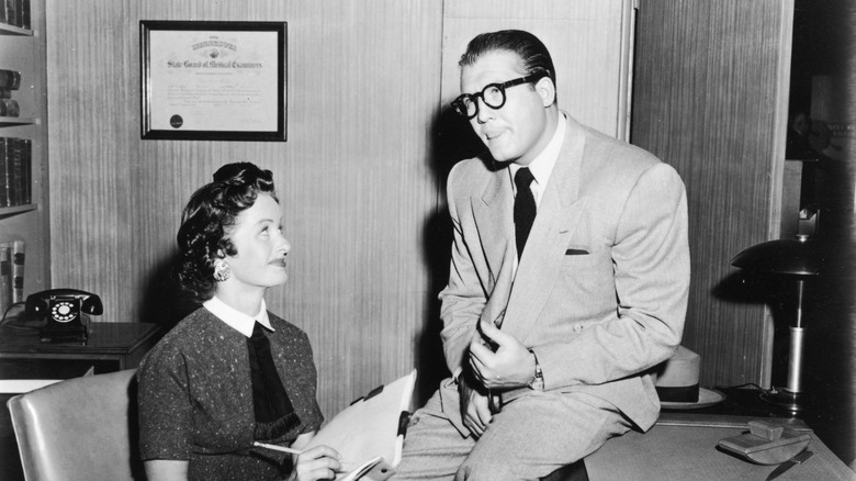 George Reeves glasses desk woman notepad