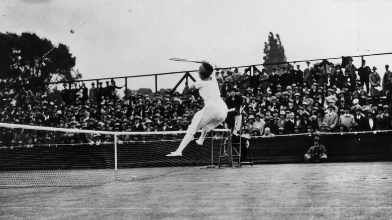 Suzanne Lenglen leaping while playing tennis