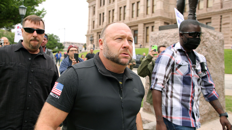 Alex Jones marching with supporters