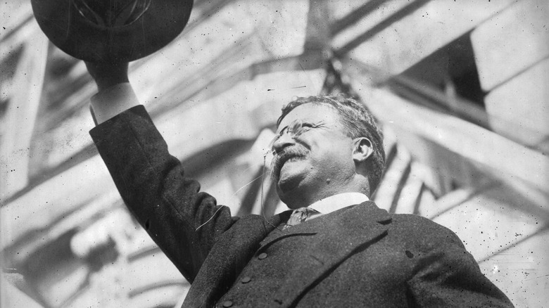 Teddy Roosevelt raises his hat