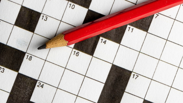 Empty crossword with red pencil closeup