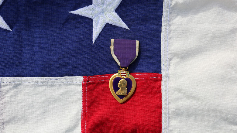 Single Purple Heart medal on American flag closeup