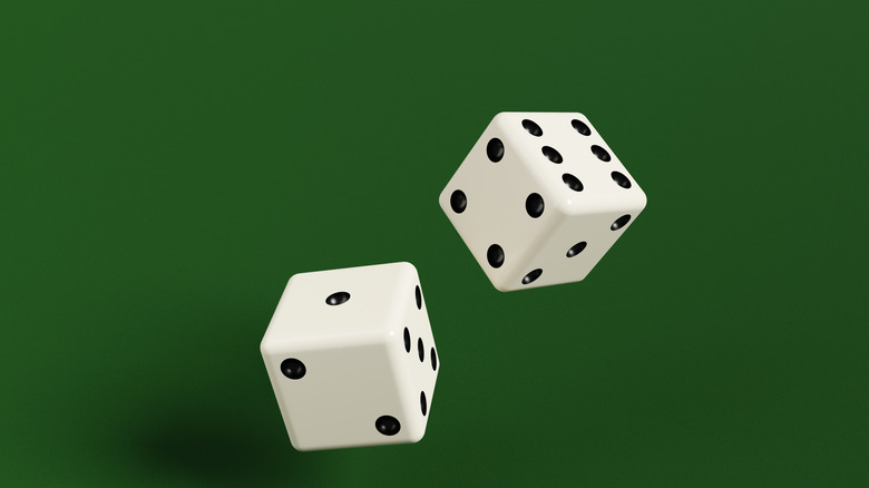 Two dice on green background.