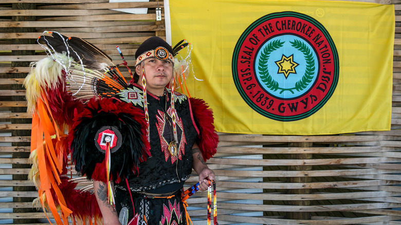 cherokee in regalia with flag