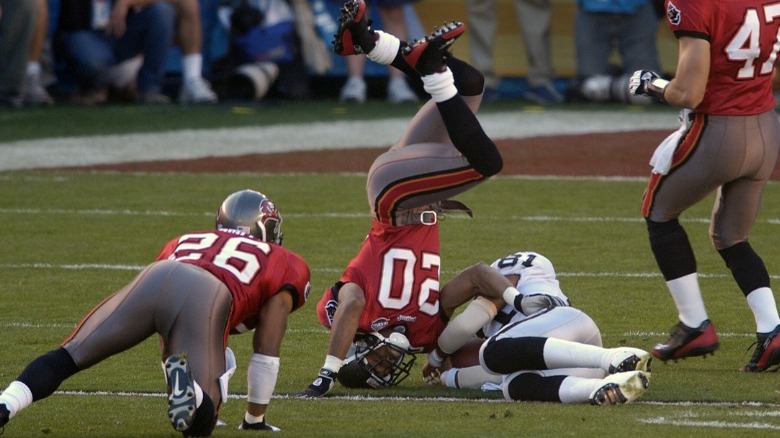 Buccaneers player tackling Raiders player