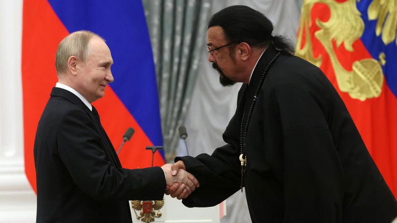 Steven Seagal bowing to and shaking hands with Vladimir Putin