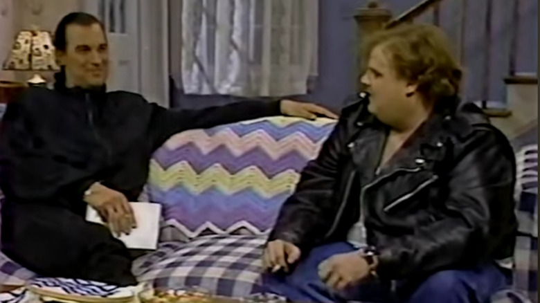 Steven Seagal sitting on a couch with Chris Farley during his SNL appearance