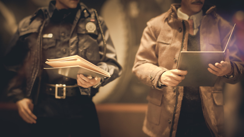 Old school police officers viewing files