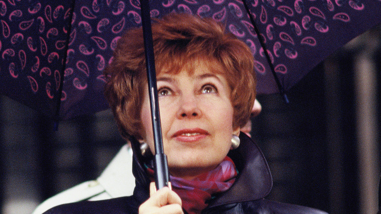 Raisa Gorbachev holds an umbrella