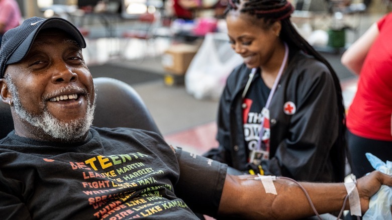 Man giving blood smiling