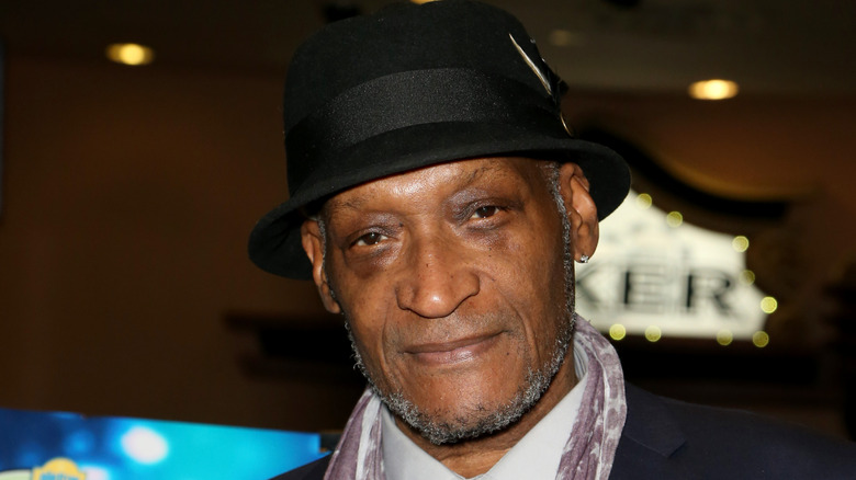 Tony Todd staring out from under black hat