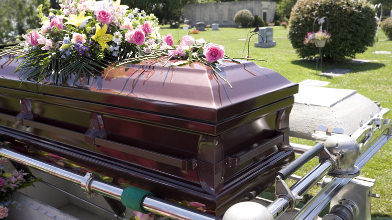 Casket at cemetery flowers