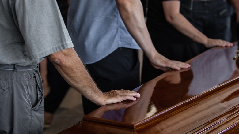 hands on casket