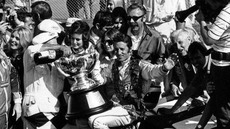 mario andretti holding trophy