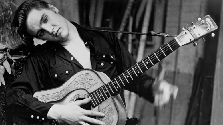 Elvis Presley holding guitar